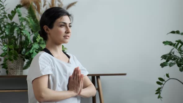 Side View Young Athletic Indian Asian Brunette Woman Doing Yoga Exercise, Looking Away and Doing alt