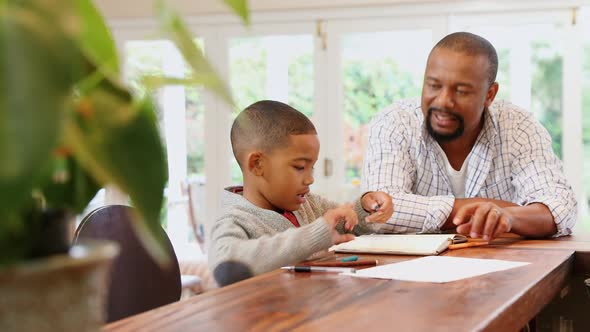 Father helping his son with his homework  alt