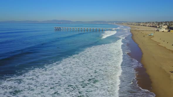 Aerial drone uav view of a pier over the beach and ocean. alt