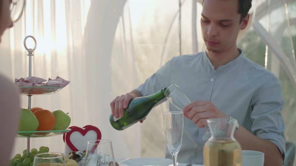 Young Couple Celebrates Anniversary with Champagne