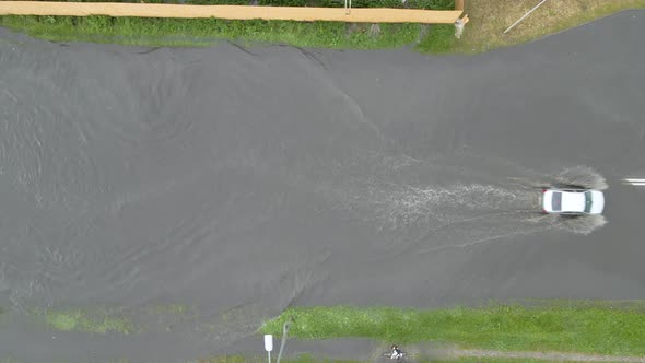Aerial View of City Traffic with Cars Driving on Flooded Street After Heavy Rain alt
