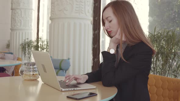 Tired and Bored Woman Is Working Alone with Notebook in Office alt