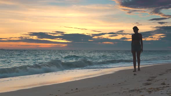 Beautiful Woman Walking Along Beach Sunset Concept