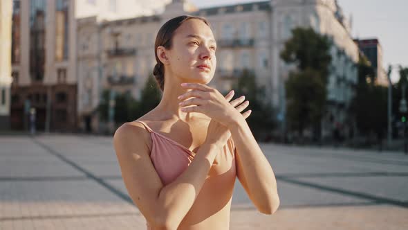 Ballet Dancer Shows Graceful Movements with Hands at Sunrise alt