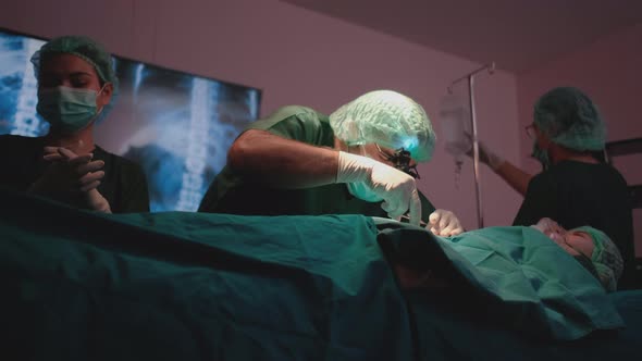 Lower view or scene of doctor try to help treat patient in operating room
