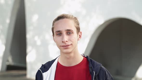 Portrait of Blond Teenager Boy Smiling and Looking at Camera with Positive Emotion Enjoying alt