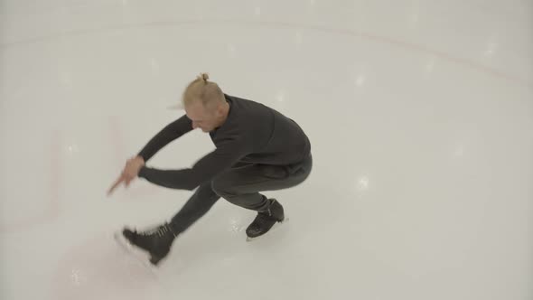 A Professional Skater Performs a Spin on Ice