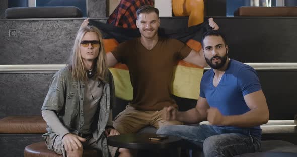 TV POV of Excited Sports Fans Cheering and Giving High-five. Portrait of Happy Middle Eastern and alt