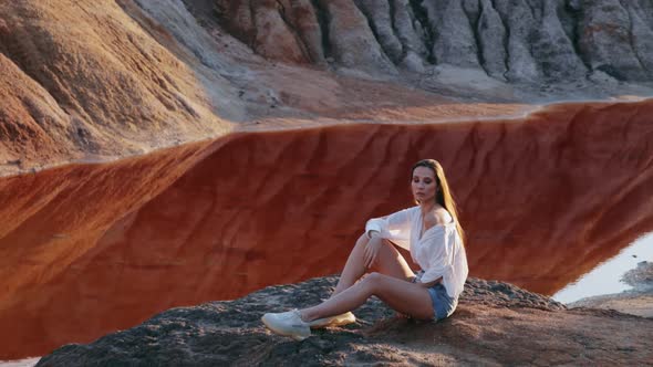 Beautiful woman posing on other-worldly hilly landscape