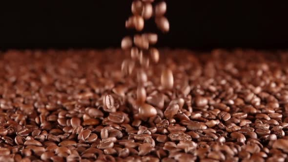 Coffee Beans Take Off From the Heap on a Black BG