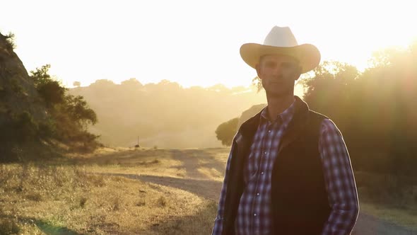 Cinematic shot of cowboy standing strong with beautiful lighting behind him alt