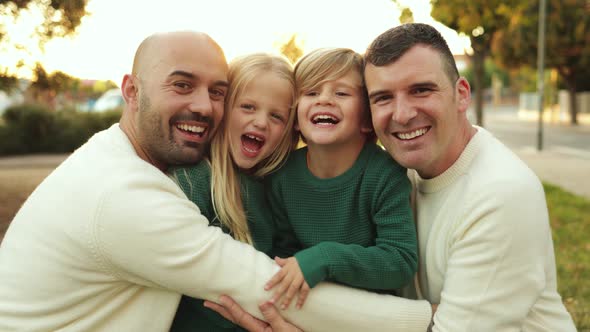 LGBT Family Outdoor  Happy Gay Men Fathers and Sons Having Fun Together at City Park alt
