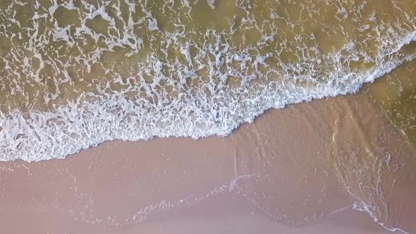 Aerial View of Sea Waves on Sandy Beach Slowmotion Shot.