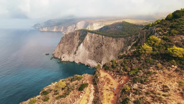 Aerial drone view of the Ionian Sea coast of Zakynthos, Greece. Tourist walking alt