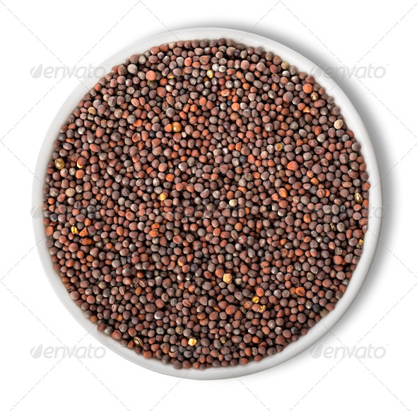 Black mustard seeds in plate isolated - Stock Photo - Images