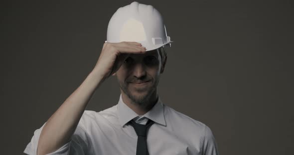 Confident architect smiling and wearing a safety helmet