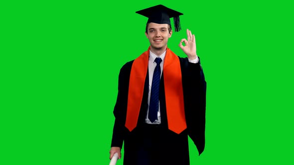 Smiling Graduating Student In Black Gown Showing Ok Sign