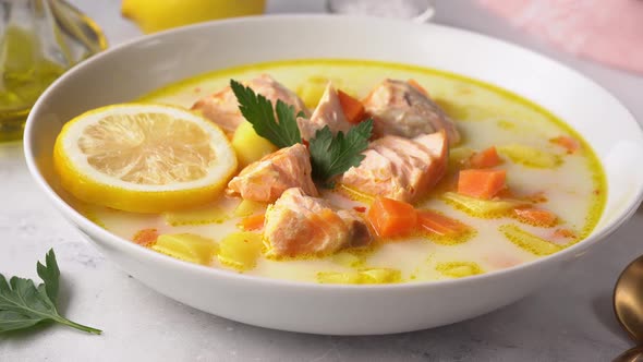 Close Up of a Plate with Delicious and Healthy Salmon Cream Soup on White Background alt