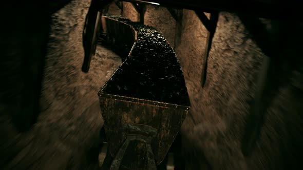 Coal mine cart speeding in a narrow underground tunnel. Dangerous dark passage. alt