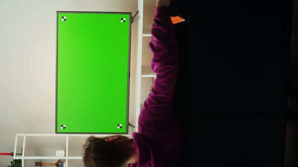 Vertical Video of Man Watching Television in Living Room alt