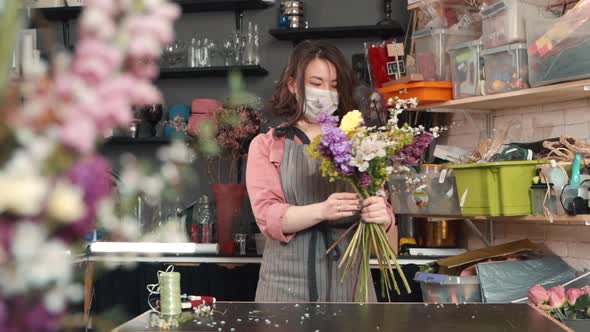 Woman Making Bouquet in Flower Shop. Female Florist Wears Mask Sick During Covid19 Pandemic