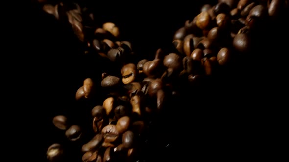 Premium Coffee Beans Flying From Both Sides in Slow Motion, Black Background