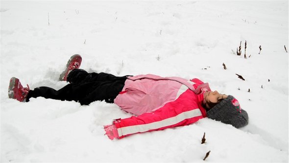 Little Girl Making Snow Angel