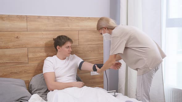 Worried Wife Take Care His Sick Husband Checking Blood Pressure