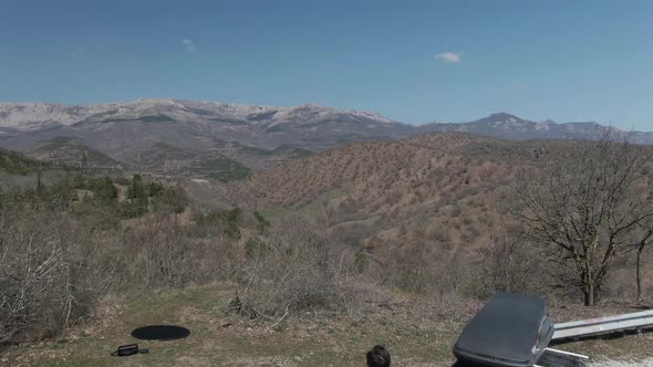 Couple of Tourist with Car Enjoy the Mountain Range Panorama Aerial Shot From Drone alt