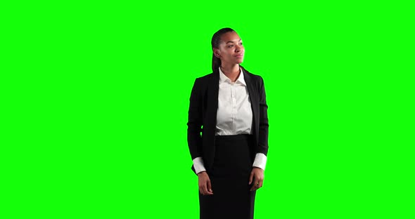 a mixed race woman in suit in a green background