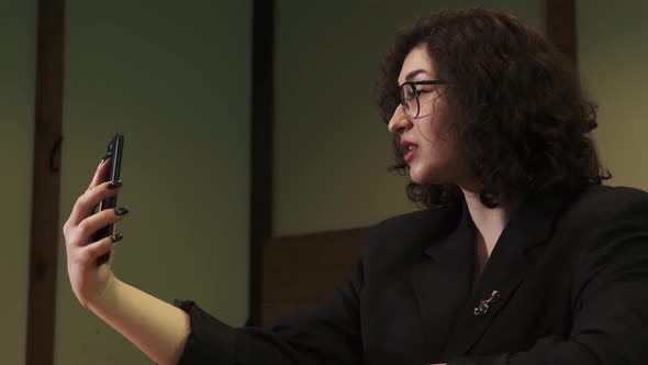 A Girl is on a Video Call with Her Phone alt