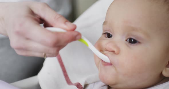 Mom Feeds Her Little 8 Months Old Baby From a Spoon
