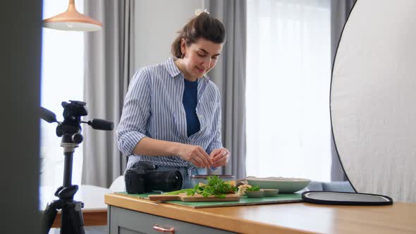 Food Photographer with Camera Working in Kitchen alt