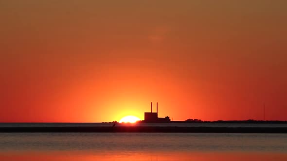 Sunset from beach in south Sweden. Power plant alt