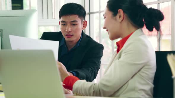 Two Business People Talk Project Strategy at Office alt