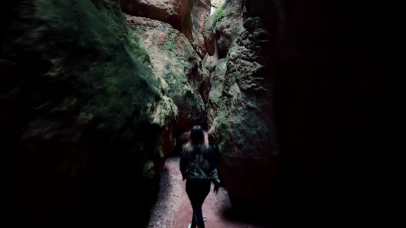 Cavern or cave exploration. Young exlorer walk through narrow paths in caves and caverns alt