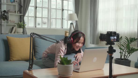 Asian Girl Vlogger Say Something And Looking Comment On Computer Laptop. The Girl Is Streaming alt