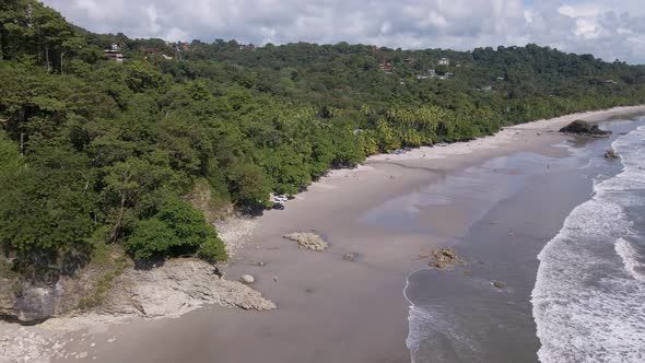 birds eye view of the shore of costa rica with the pacific ocean where the beach goes over into the alt