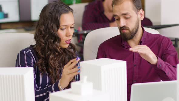 Team of Architects in a Meeting Talking About Business Buildings alt