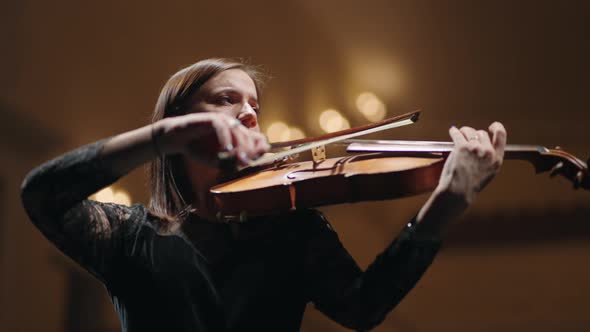 Brunette Lady in Black is Playing Fiddle in Philharmonic Hall Female Musician in Symphonic Orchestra alt