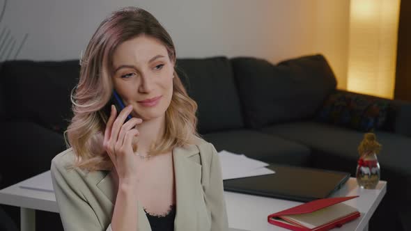 Blonde pretty  woman have an important phone conversation. alt