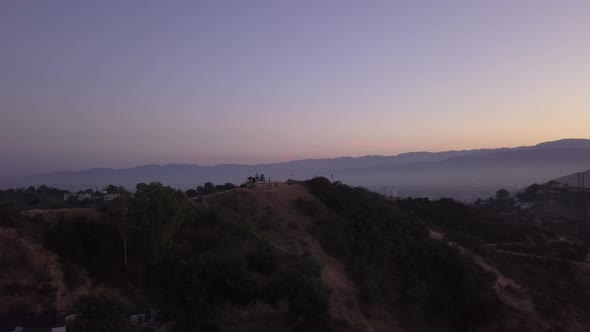 Purple Sunrise Scenic View Above Hollywood Hills Mountains Near Los Angeles in California Aerial alt