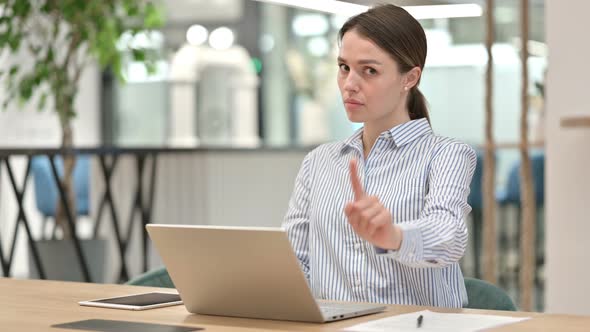 Serious Young Woman with Laptop Saying No By Head Shake  alt