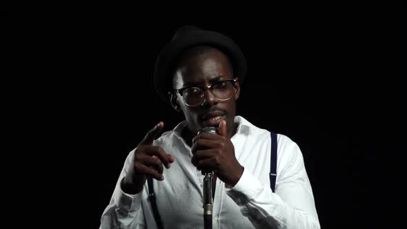 Artist Music Recording a Track in the Studio with Music Producer. Black Background. Slow Motion alt