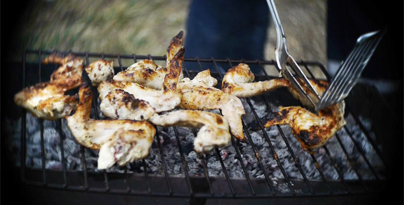 Man Cooks The Wings On The Grill