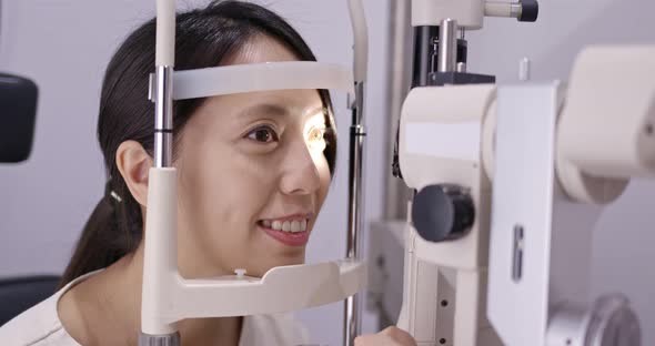 Woman check on eye in clinic alt