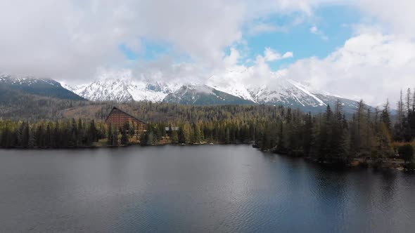 Aerial View of Strbske Pleso, Slovakia. Mountain Lake in Clouds and Snowy Tatras Mountains alt