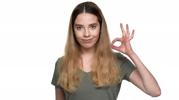 Portrait of Caucasian Woman 20s in Casual Clothing Smiling and Showing Ok Sign with Fingers Isolated alt