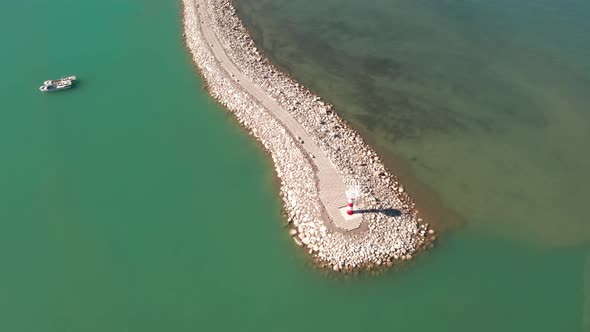 Lake and lighthouse in a sunny day alt
