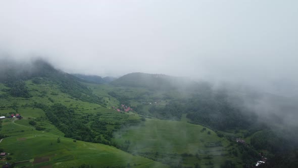 Flying Over Misty Mountains and Hills in the Countryside